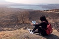 Traveler woman sitting at the mountain