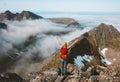 Traveler woman success raised hands climbing on mountain top above clouds Royalty Free Stock Photo