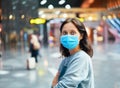Traveler woman in virus protection face mask in international airport