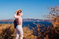 Traveler woman walking on Santorini island, Greece enjoying landscape. Happy girl enjoys Caldera view Royalty Free Stock Photo