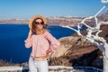 Traveler woman walking on Santorini island, Greece enjoying landscape. Happy girl enjoys Caldera view Royalty Free Stock Photo