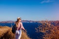 Traveler woman walking on Santorini island, Greece enjoying landscape. Happy hiker enjoys Caldera view Royalty Free Stock Photo