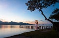 Traveler woman on wooden bridge at mountain sunrise