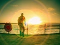 Traveler on wooden pier or jetty waiting for ferry boat Royalty Free Stock Photo