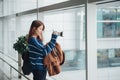 Traveler young asian girl with backpack taking a photo with her digital camera Royalty Free Stock Photo