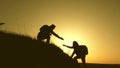 Travelers climb the cliff holding hand. teamwork of business people. Happy family on vacation. traveler man extends his