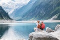 Travelers couple look at the mountain lake. Travel and active life concept with team. Royalty Free Stock Photo