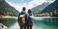 Travelers couple look at the mountain lake. Travel and active life concept with team. Adventure and travel in the mountains region Royalty Free Stock Photo