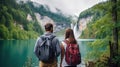 Travelers couple look at the mountain lake. Travel and active life concept with team. Adventure and travel in the mountains region Royalty Free Stock Photo