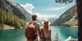 Travelers couple look at the mountain lake. Travel and active life concept with team. Adventure and travel in the mountains region Royalty Free Stock Photo