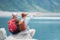 Travelers couple look at the mountain lake. Travel and active life concept with team. Adventure and travel in the mountains region