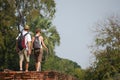 Travelers foreign couple backpack and lovers travel visit ancient antiquity architecture and antique ruins building at Si