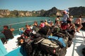 Travelers go on a ferry across the sea to the islands with large backpacks