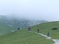 Travelers going hiking on mountainious path. Active people