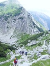 Travelers going hiking on mountainious path. Mountainious panorama