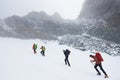 Travelers hiking in winter mountains. Royalty Free Stock Photo