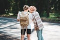 Travelers hipsters woman and man with backpack hold in hands location map and searching directional among trees