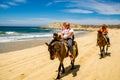 Travelers horseback riding in Cabo San Lucas.