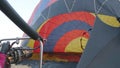 Travelers inflate the balloon with warm air and prepare to fly in a balloon above the clouds. Preparing for a balloon