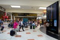 Travelers and people at England's London Gatwick Airport departure lounge with flight display Royalty Free Stock Photo