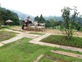 Travelers and photographer thai men travel visit and sitting rest relaxon wooden chair at outdoor garden of countryside rural at