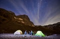 Travelers sitting by tents in Matterhorn mountains. Royalty Free Stock Photo