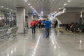 Travelers with suitcases walking through the airport. Passengers walk through the airport