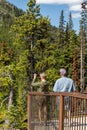 Travelers taking snapshot on smart phone of North Cascade Mountains