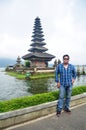 Travelers thai men travel visit and respect praying of Pura Ulun Danu Bratan in Bali, Indonesia Royalty Free Stock Photo