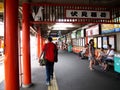 Travelers thai man walking and japanese passengers people use service journey by railway in Fushimi - Inari train station for Royalty Free Stock Photo