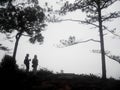 Travelers thai people couple lovers wear raincoat travel visit in forest jungle and camping top mountain for travel while raining