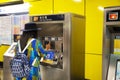 Travelers thai woman buying ticket train subway from automatic sale ticket box in Mong Kok railway station at Kowloon in Hong Kong Royalty Free Stock Photo