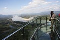 Travelers thai woman people travel visit and posing for take photo view on glass skywalk of cliffs at Wat Pha Tak Suea temple in