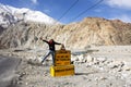 Thai woman visit and pose portrait for take photo with Milestone on Pangong lake road at Leh Ladakh in Jammu and Kashmir, India