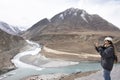 Travelers thai woman travel visit and posing portrait for take photo at view point of Confluence of the Indus and Zanskar Rivers Royalty Free Stock Photo