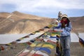 Travelers thai woman travel visit stand for take photo with Prayer flag for blessing at viewpoint with mountains and Pangong lake