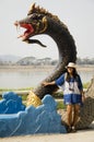 Travelers thai woman visit and posing for take photo with naga statue at mae khong riverside