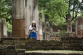 Travelers thai woman walking visit and travel take photo in ancient building and ruins of Kamphaeng Phet Historical Park