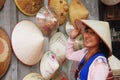 Travelers thai women people travel visit and shopping select vietnamese straw hat in local souvenir gift shop in Ba Dinh Old Town