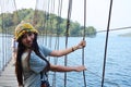 Travelers thai women photographer travel visit and posing portrait take photo on wooden suspension bridge  crossing lake to island Royalty Free Stock Photo