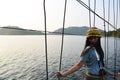 Travelers thai women photographer travel visit and posing portrait take photo on wooden suspension bridge  crossing lake to island Royalty Free Stock Photo