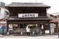 Thai women travel and portrait posing for take photo in Naritasan Omote Sando or Old Japanese Narita town at Chiba in Tokyo, Japan