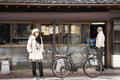 Thai women travel and portrait posing for take photo in Naritasan Omote Sando or Old Japanese Narita town at Chiba in Tokyo, Japan