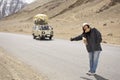 Travelers thai women travel visit and hitchhike vehicle on Srinagar highway at Leh Ladakh while winter season in Jammu and Kashmir