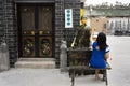 Thai women visit and posing for take photo with fortune teller statue in small alley at Shantou or Swatow in Guangdong, China