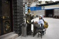 Thai women visit and posing for take photo with fortune teller statue in small alley at Shantou or Swatow in Guangdong, China