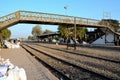 Travelers and traders wait with goods at train station platform Mirpurkhas Sindh Pakistan