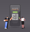 travelers using digital immunity passport with qr code on smartphone screen risk free covid-19 pandemic