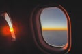 Travelers wake up from the sunlight catching the eyes from the window on the plane.