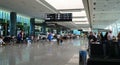 Travelers Walking Along An Airport Corridor